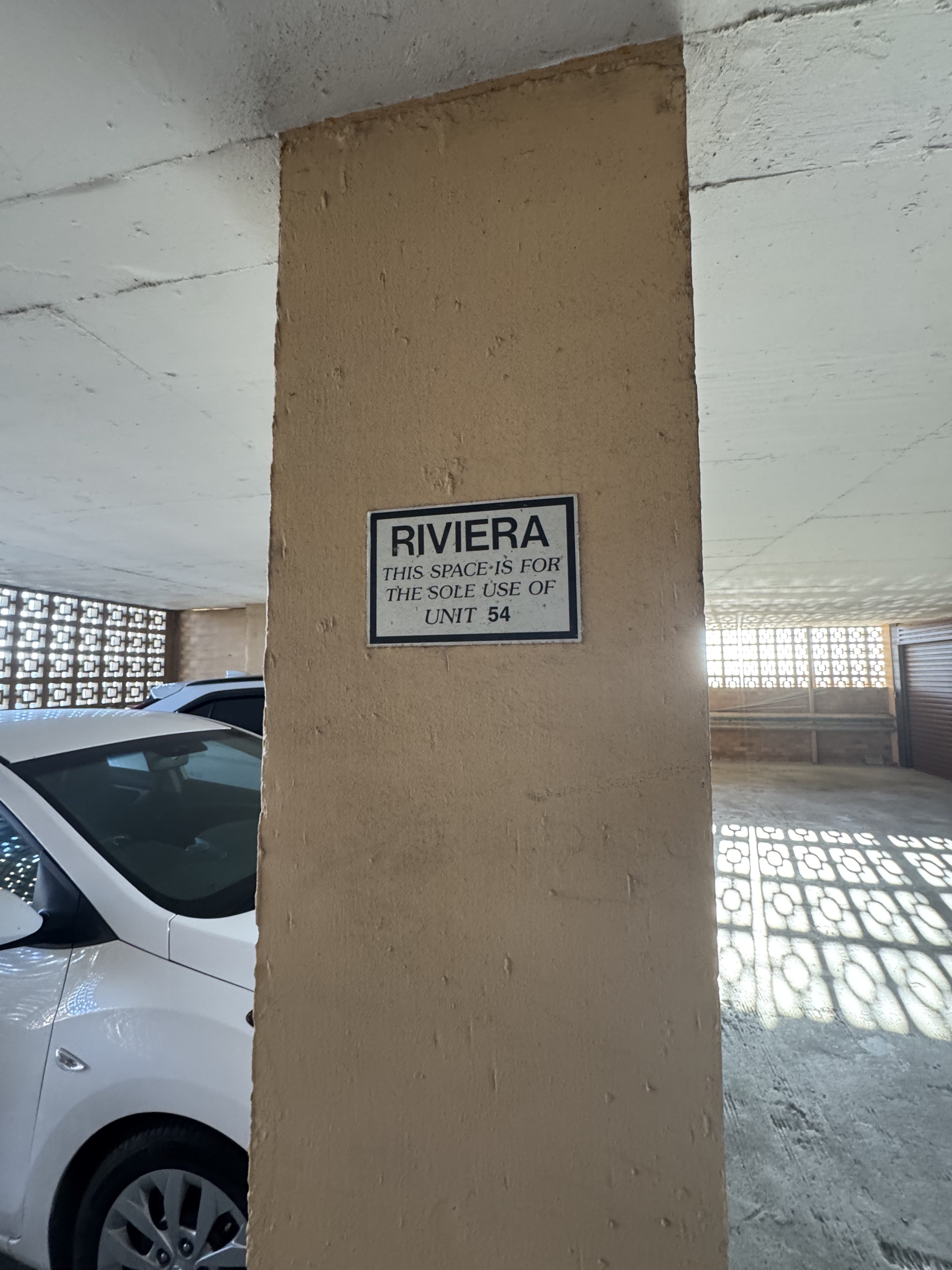 The Unit 54 sign marking the neighbour's parking space