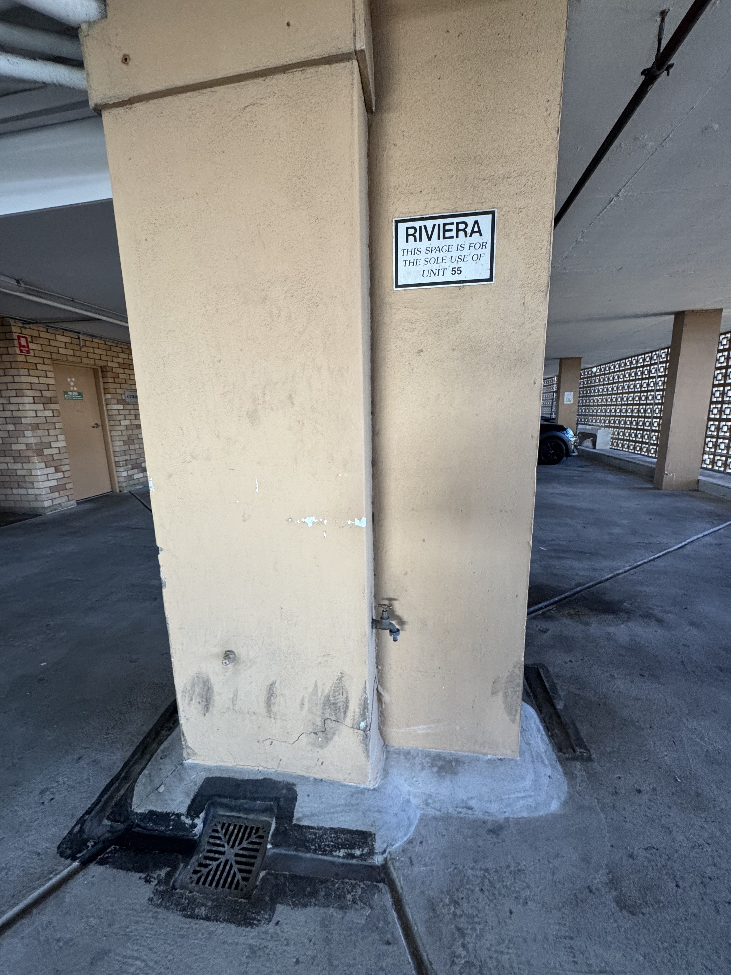 The Unit 55 sign on the back of the right hand pillar in the car park